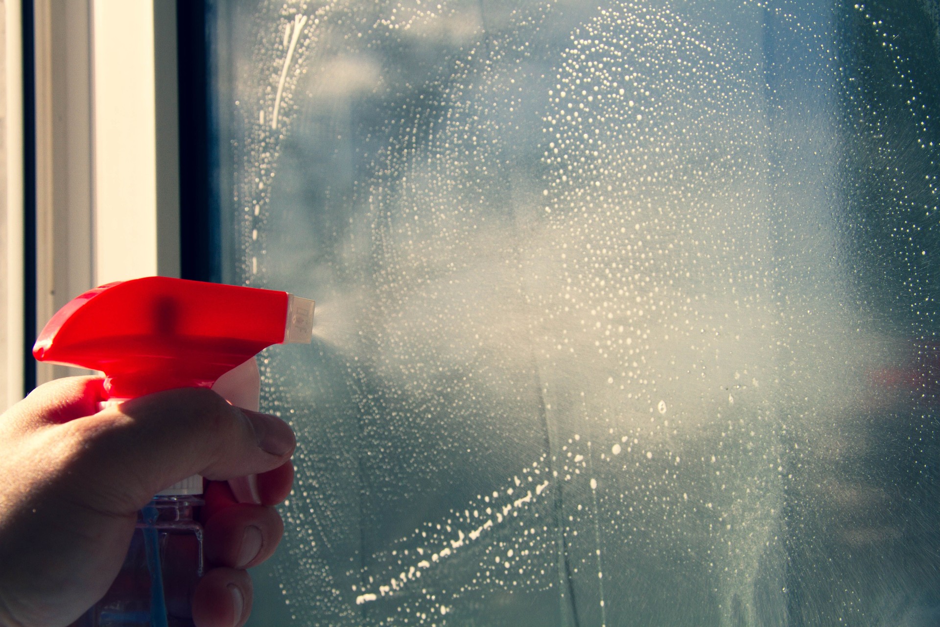 Window washing. Cleaning the window with a brush and foam. The concept of cleanliness and cleaning.